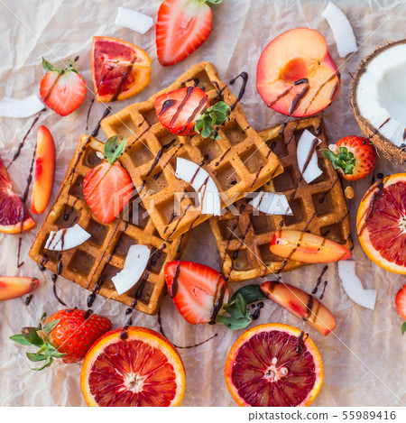 Waffles with strawberries, coconut, plum Waffles with strawberries, coconut, plum 55989416
