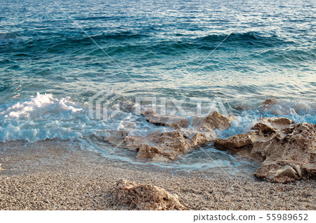 Rocky beach and crystal turquoise water of Ionian Sea in Albania. Calm and relaxing view Rocky beach and crystal turquoise water of Ionian Sea in Albania. Calm and relaxing view 55989652