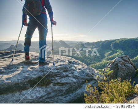 Man with fixed leg makes step with help of forearm 55989854