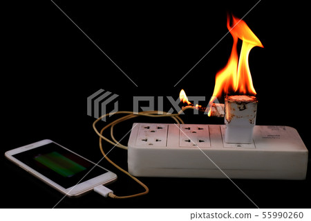 On fire Adapter smart phone charger at plug in pow On fire Adapter smart phone charger at plug in pow 55990260