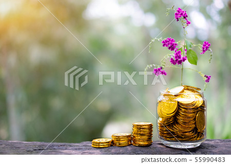 Tree with flowers growing on glass piggy bank from 55990483
