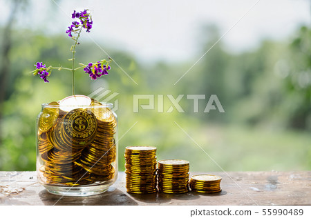 Tree with flowers growing on glass piggy bank from 55990489