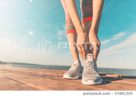 Legs in sneakers close-up. Health and Yoga Concept. Rear view close up strong athletic female legs 55991305