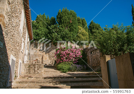 Stone house with staircase and flowers 55991763