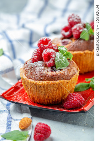 Mini tarts with raspberry, frangipani and mint. 55992634