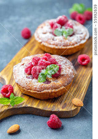 Delicious mini-tarts (tartlets) with raspberries. Delicious mini-tarts (tartlets) with raspberries. 55992639