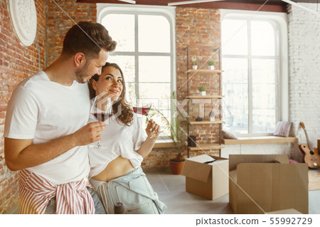 Young couple moved to a new house or apartment Young couple moved to a new house or apartment 55992729