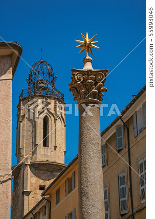 Column with golden star and bell tower in France Column with golden star and bell tower in France 55993046
