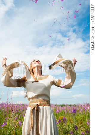 Beautiful woman relaxing on meadow with flowers 55993317