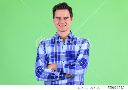 Happy young handsome hipster man smiling with arms crossed Happy young handsome hipster man smiling with arms crossed 55994281