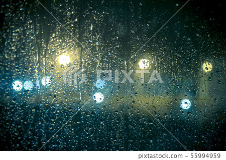 At night outside the window it is raining At night outside the window it is raining 55994959