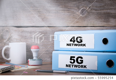 5G and 4G network. Two binders on desk  55995254
