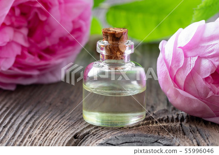 A bottle of rose essential oil with rose de mai 55996046