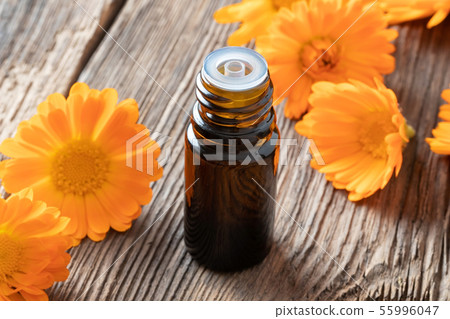 A bottle of calendula essential oil with calendula 55996047