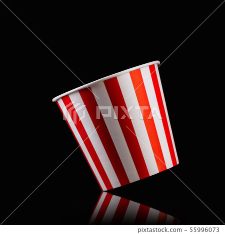 Empty popcorn striped bucket isolated on black background Empty popcorn striped bucket isolated on black background 55996073