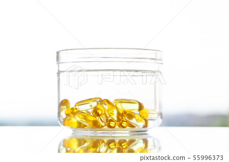Vitamins supplements, fish oil in yellow capsules omega 3. Vitamins supplements, fish oil in yellow capsules omega 3. 55996373