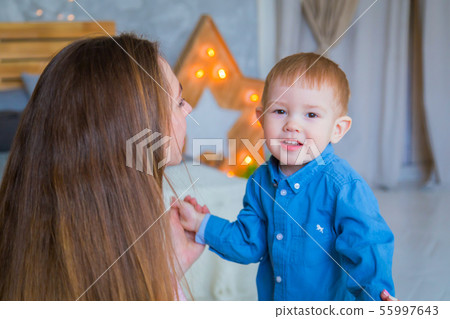 Happy young mother and her baby son playing togerher 55997643