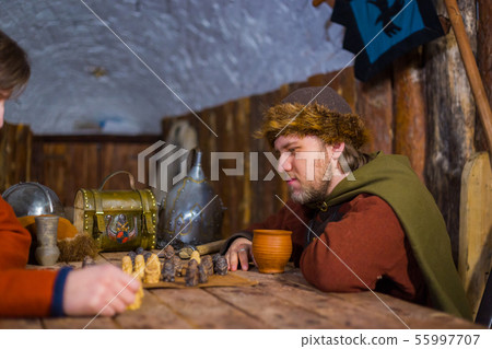 Two men playing popular strategy board game - tafl 55997707