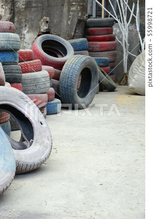 A picture of many old used tires left on a waste A picture of many old used tires left on a waste 55998721