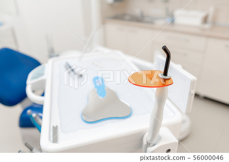 Dental polymerization lamp with UV light and laser. Stomatological instrument in the dentist clinic 56000046