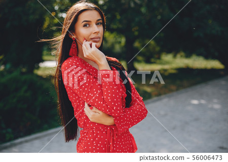 Elegant brunette in a summer city 56006473