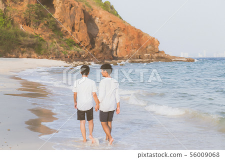 Back view homosexual young asian couple on beach Back view homosexual young asian couple on beach 56009068