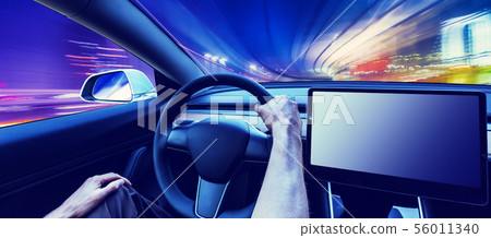 Person driving a new electric vehicle Person driving a new electric vehicle 56011340