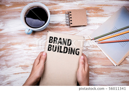 Brand Building concept. Hands holding book Brand Building concept. Hands holding book 56011341