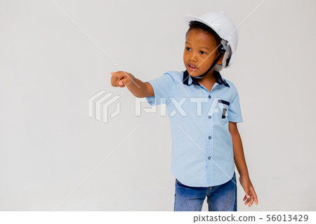 Little ethnic boy standing in white helmet 56013429