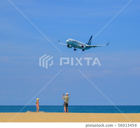 Airplane landing at Phuket Airport Airplane landing at Phuket Airport 56013459