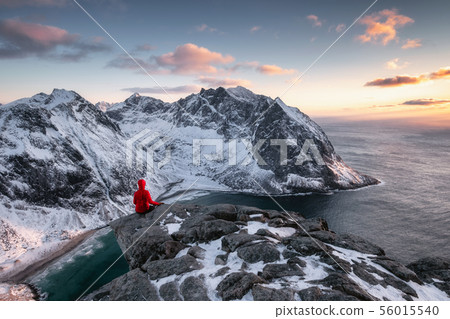 Mountaineer sightseeing on ridge with arctic ocean 56015540