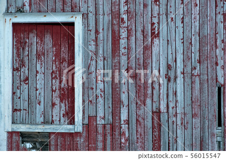 Weathered red wooden wall with window Weathered red wooden wall with window 56015547
