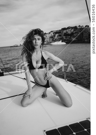 Fashion outdoor photo of beautiful young woman posing on a yachts 56016436