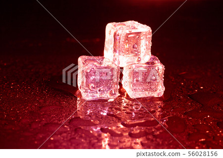 ice cubes on a reflections red light. 56028156