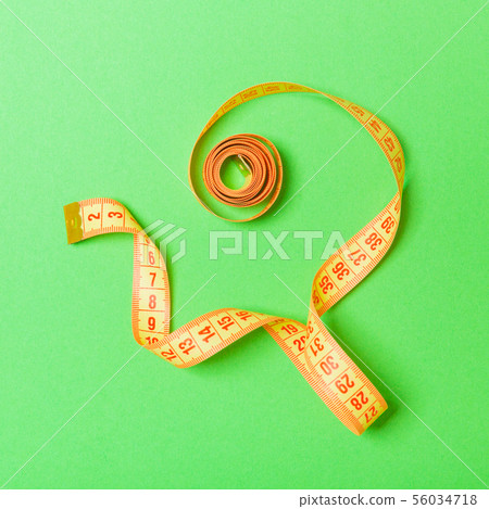 Top view of curled measuring tape as a sewing Top view of curled measuring tape as a sewing 56034718