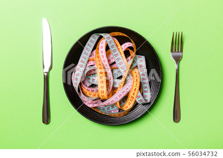 Top view of heap of colorful measuring tapes in 56034732