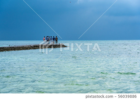 Tourists who enjoy taking a drone at the popular West Pier in Taketomi Island, Okinawa 56039886