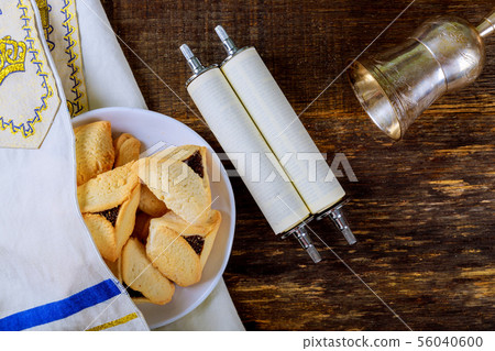 Hamantaschen cookies and masks on wood desk 56040600