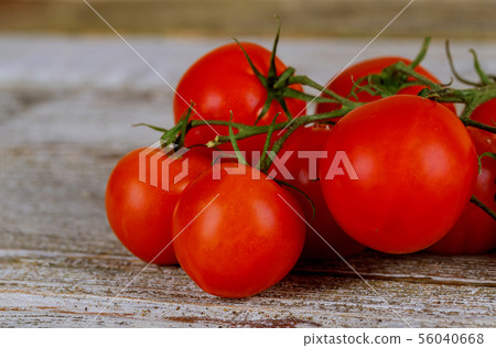Fresh tomatoes on wooden table close up 56040668