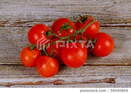 Tomatoes on the vine on rustic wooden background 56040669
