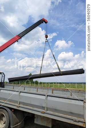 The truck crane in the field on the private land 56040979