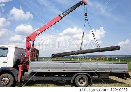 The truck crane in the field on the private land 56040982