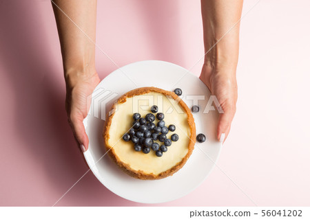 Top view of woman holding cheesecake with Top view of woman holding cheesecake with 56041202
