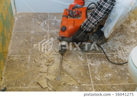 Worker remove, demolish old tiles in a bathroom 56041275
