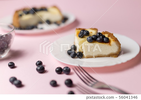 Plate with two pieces of delicious cheesecake. Plate with two pieces of delicious cheesecake. 56041346