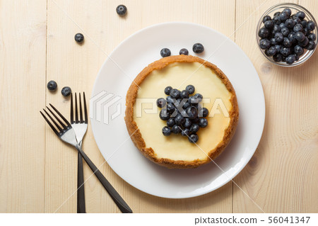 Plate with delicious cheesecake and two forks on 56041347
