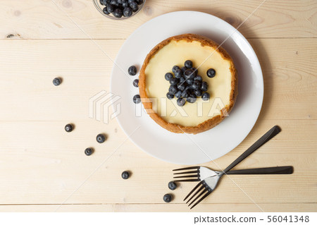Plate with delicious cheesecake and two forks on 56041348