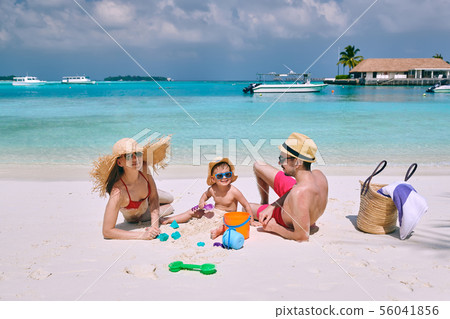 Family with three year old boy on beach 56041856