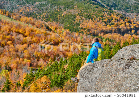 Backpacker man at Artist's Bluff in autumn 56041981