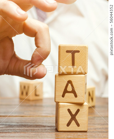 Businessman removes wooden blocks Businessman removes wooden blocks 56044352